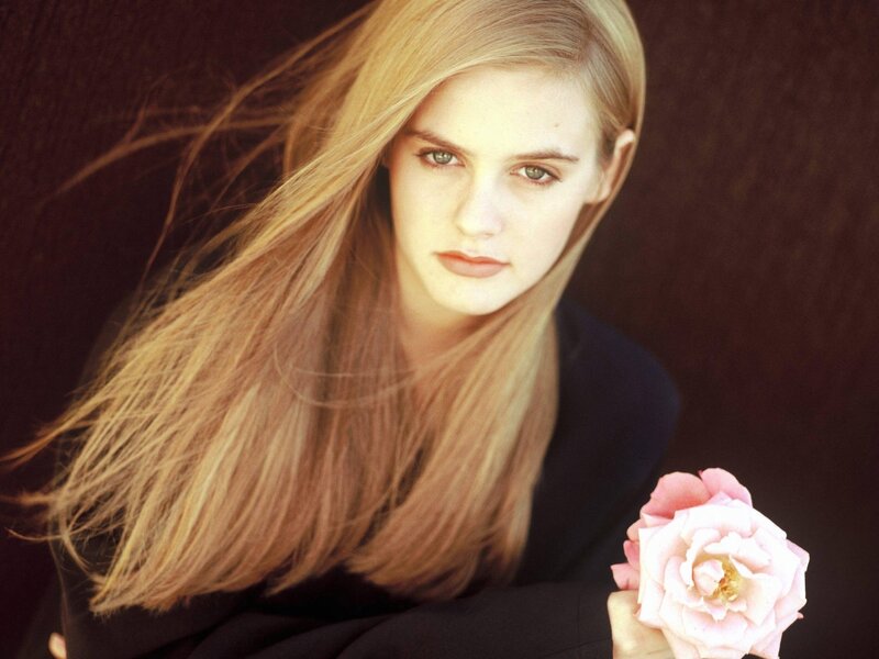 woman holding a pink rose