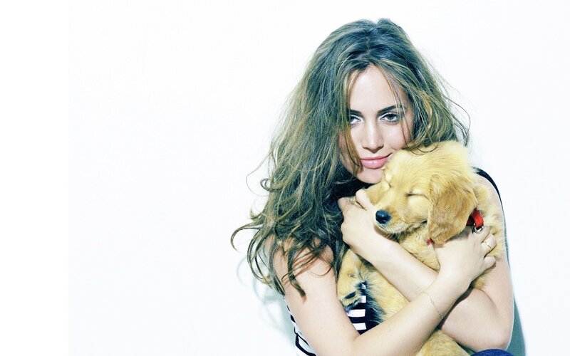 woman holding a puppy