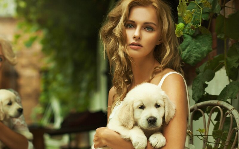 woman holding a puppy