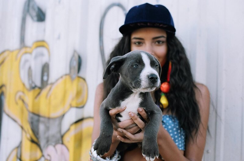 woman holding a puppy