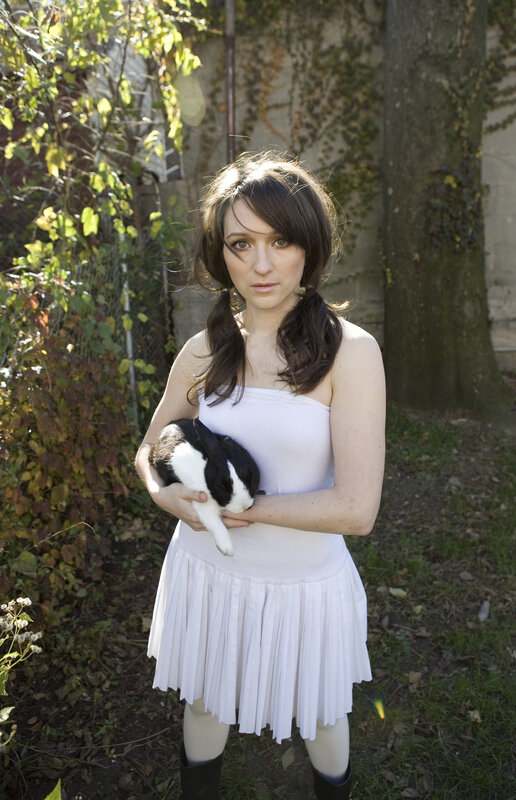 Woman holding a rabbit outdoors