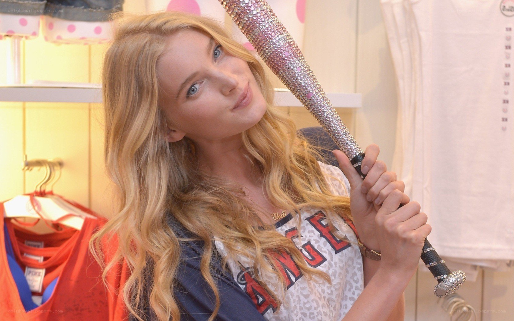 Woman holding a rhinestone bat