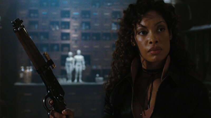 Woman holding a rifle in a lab