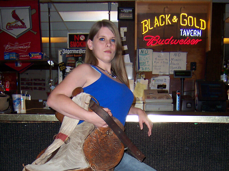 Woman Holding a Saddle