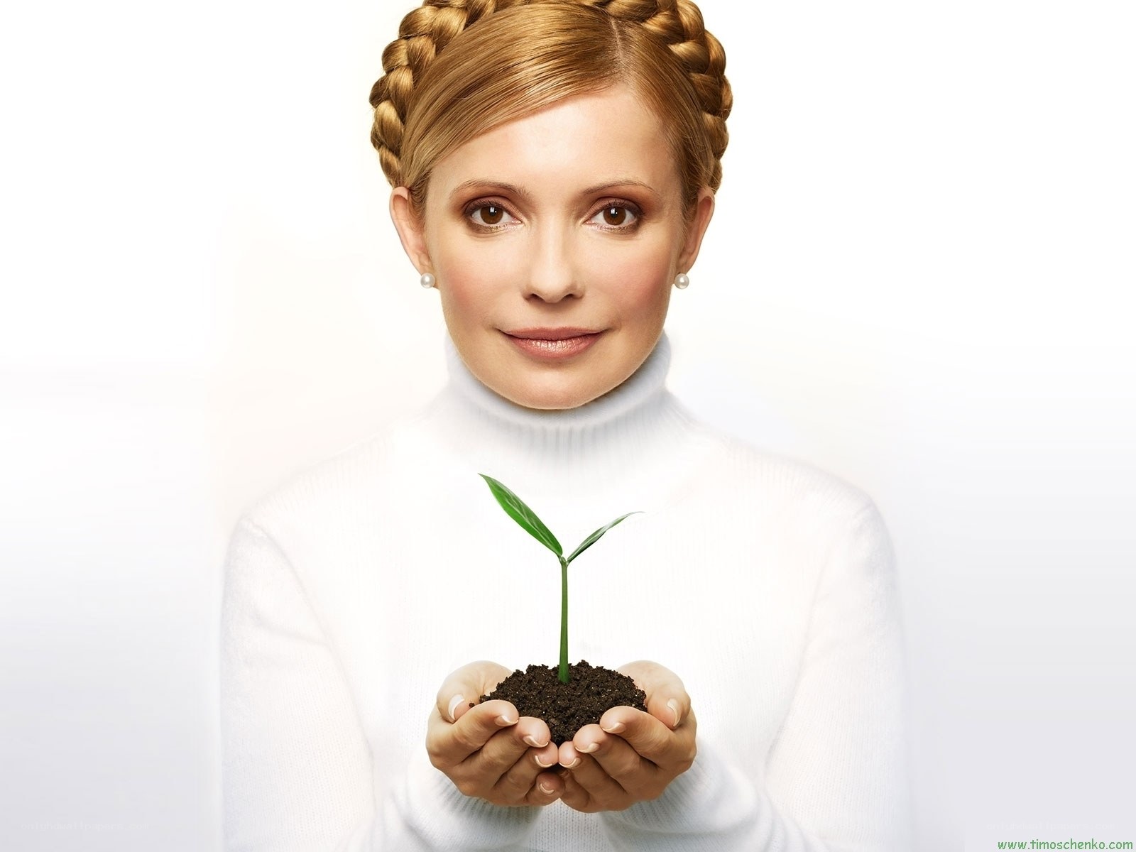 woman holding a seedling