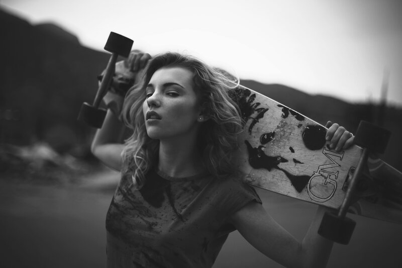 woman holding a skateboard