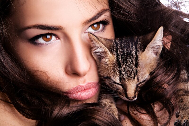 woman holding a sleeping kitten