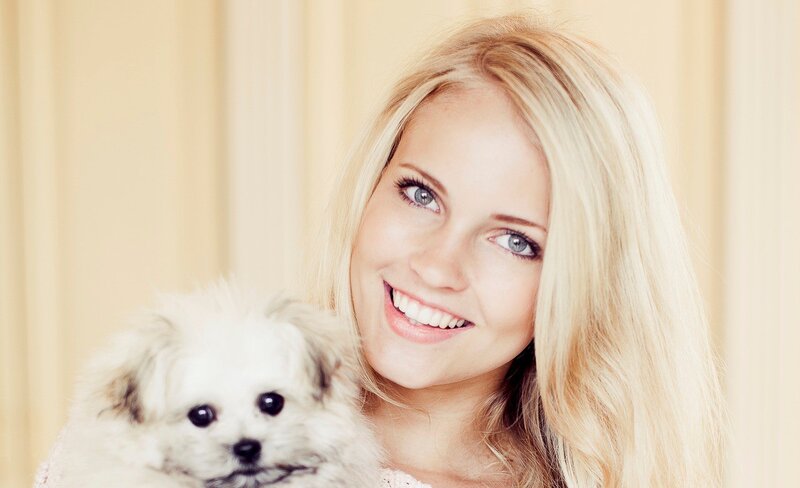 woman holding a small dog