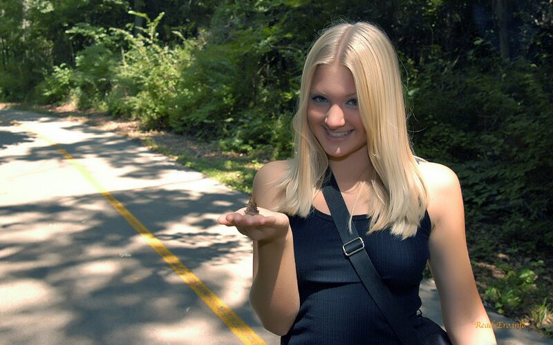 Woman holding a snail on a path
