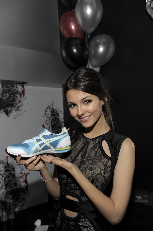 woman holding a sneaker