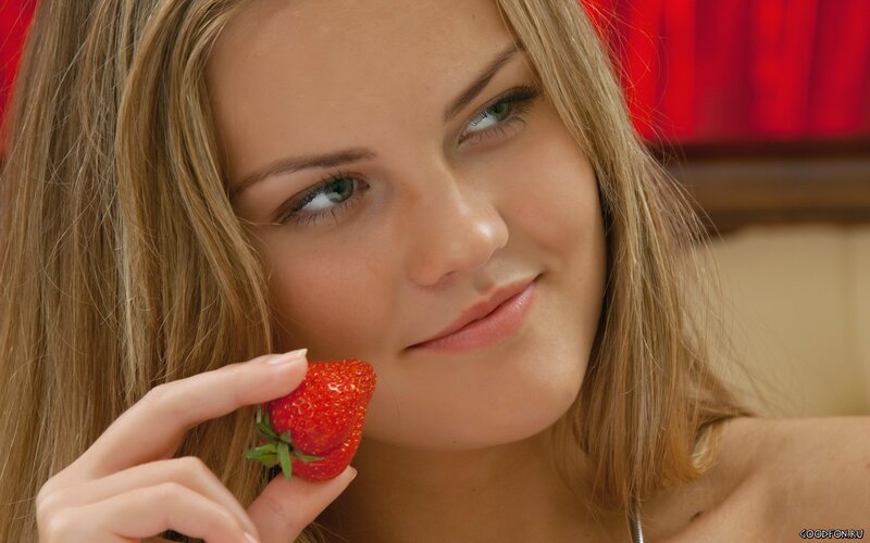 woman holding a strawberry
