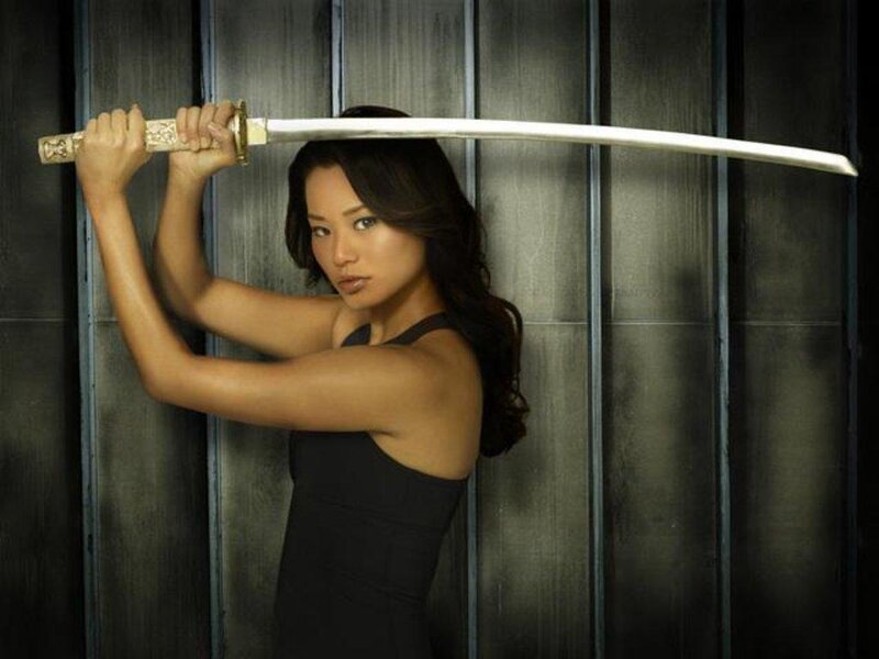 Woman Holding a Sword — Black, Serious
