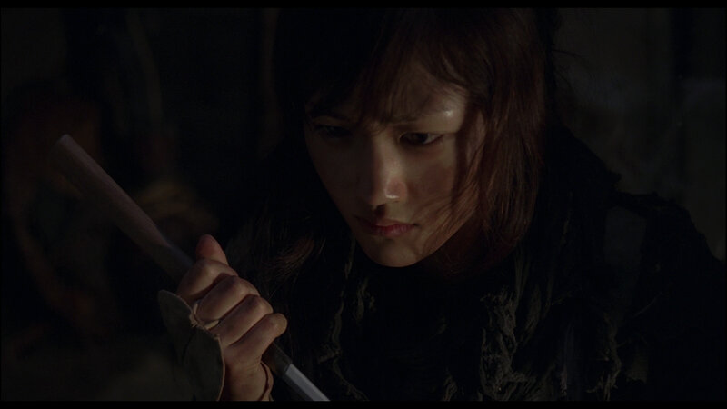 woman holding a sword in dark