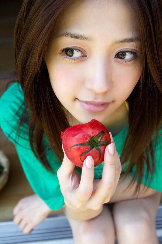 Woman holding a tomato