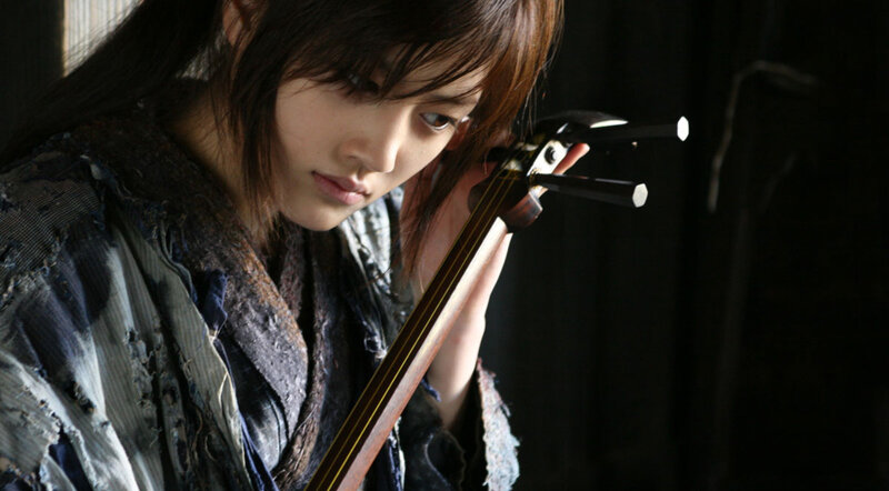 woman holding a traditional instrument