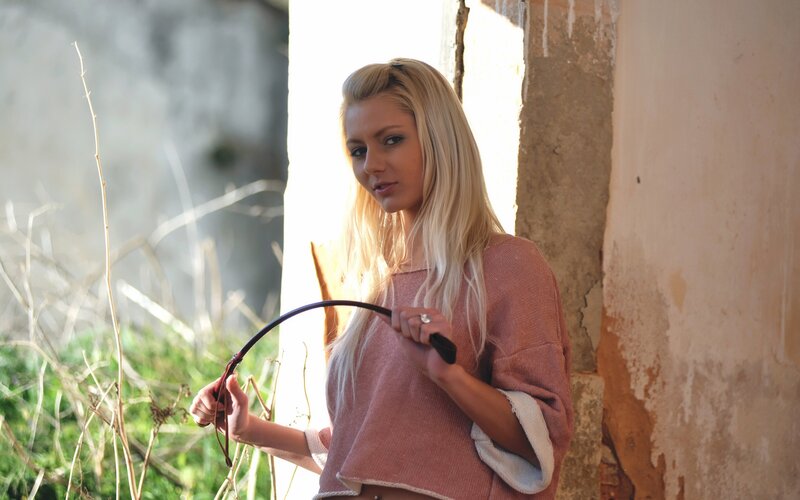 Woman holding a whip