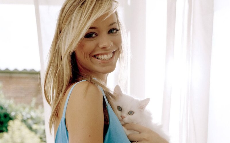 Woman holding a white cat