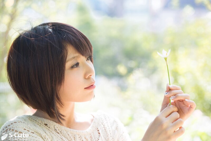 woman holding a white flower
