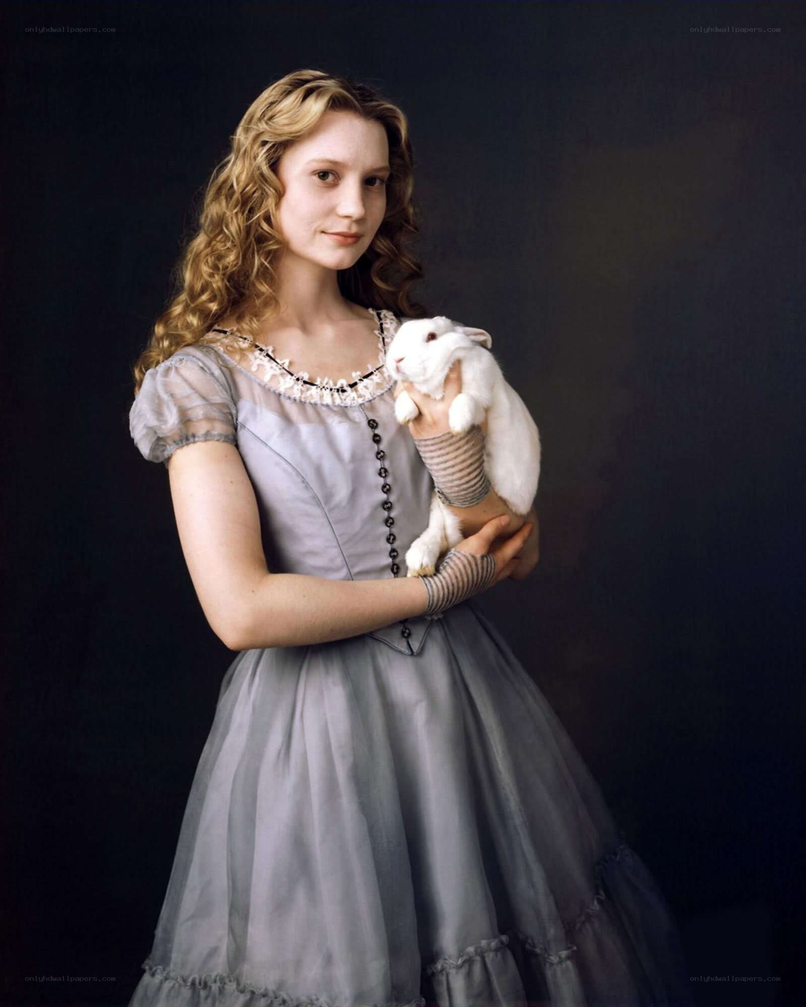 Woman holding a white rabbit