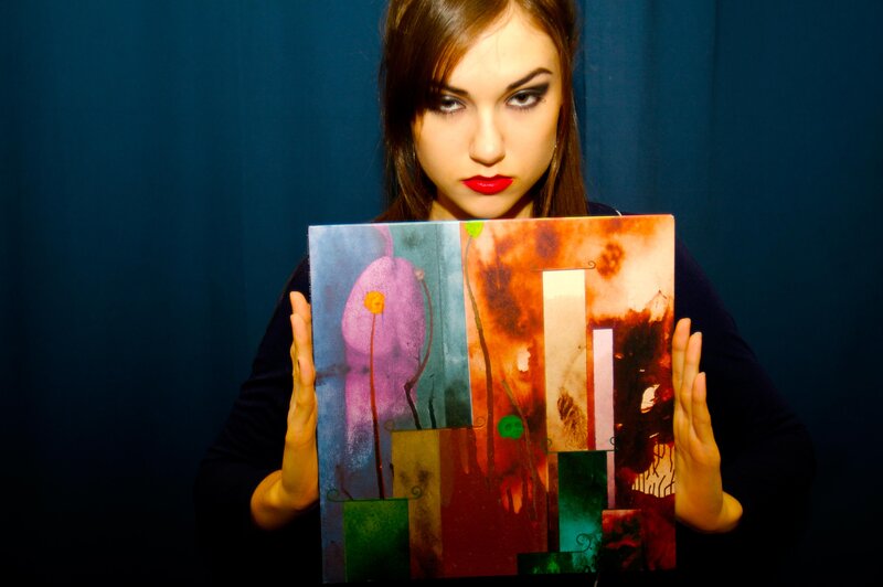 woman holding abstract art