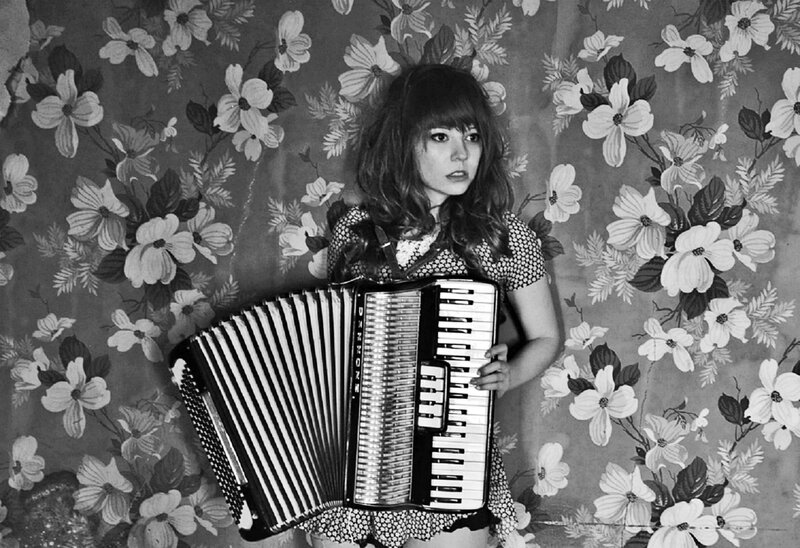 Woman Holding Accordion — Black