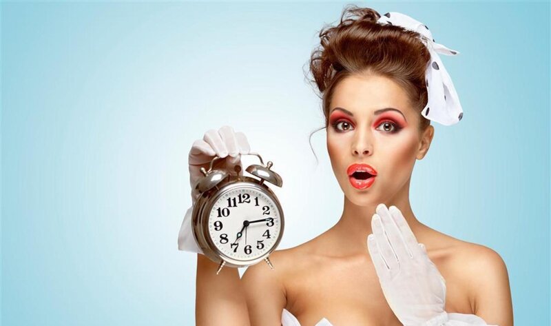Woman Holding Alarm Clock
