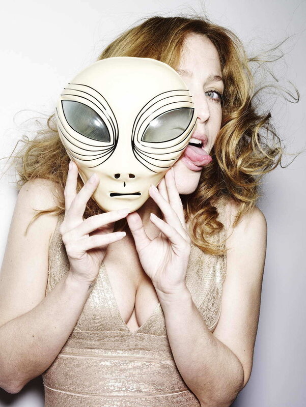 Woman holding alien mask