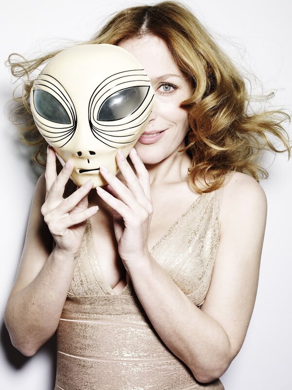 Woman holding alien mask