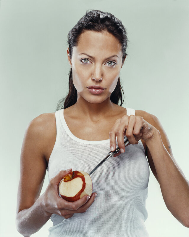 woman holding apple and knife
