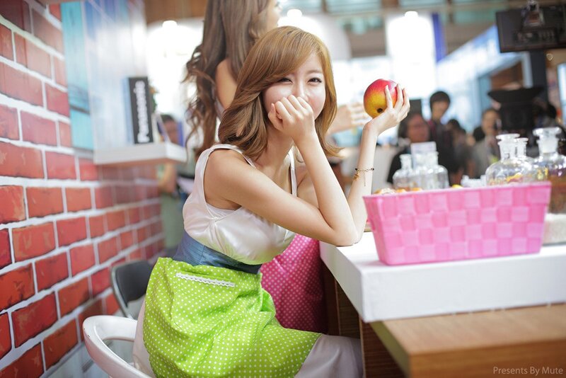 woman holding apple at counter