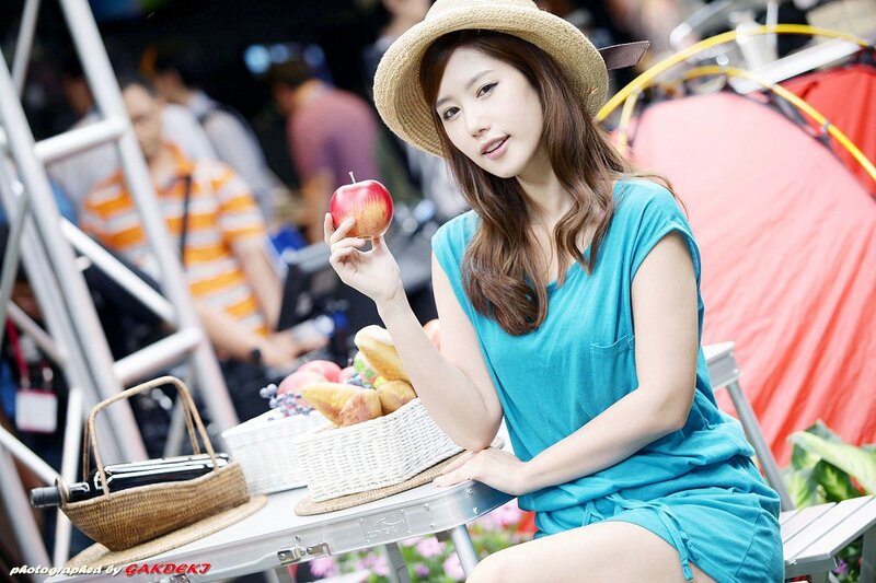 woman holding apple at picnic