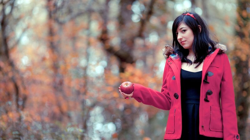 woman holding apple in autumn