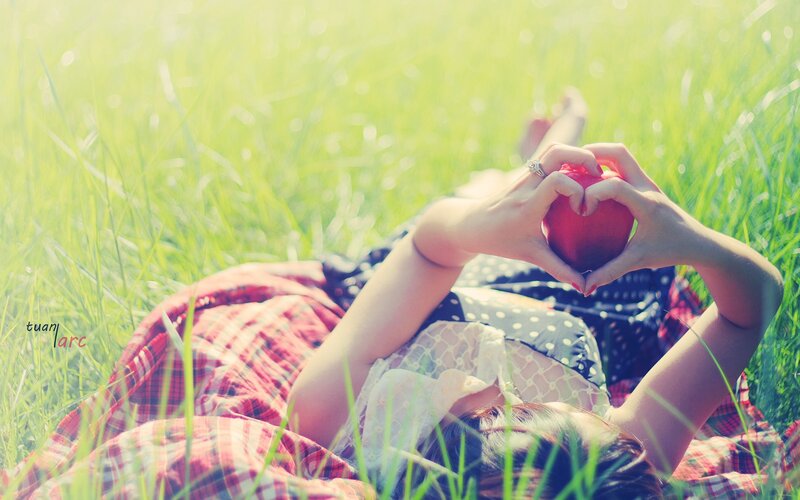 woman holding apple in field