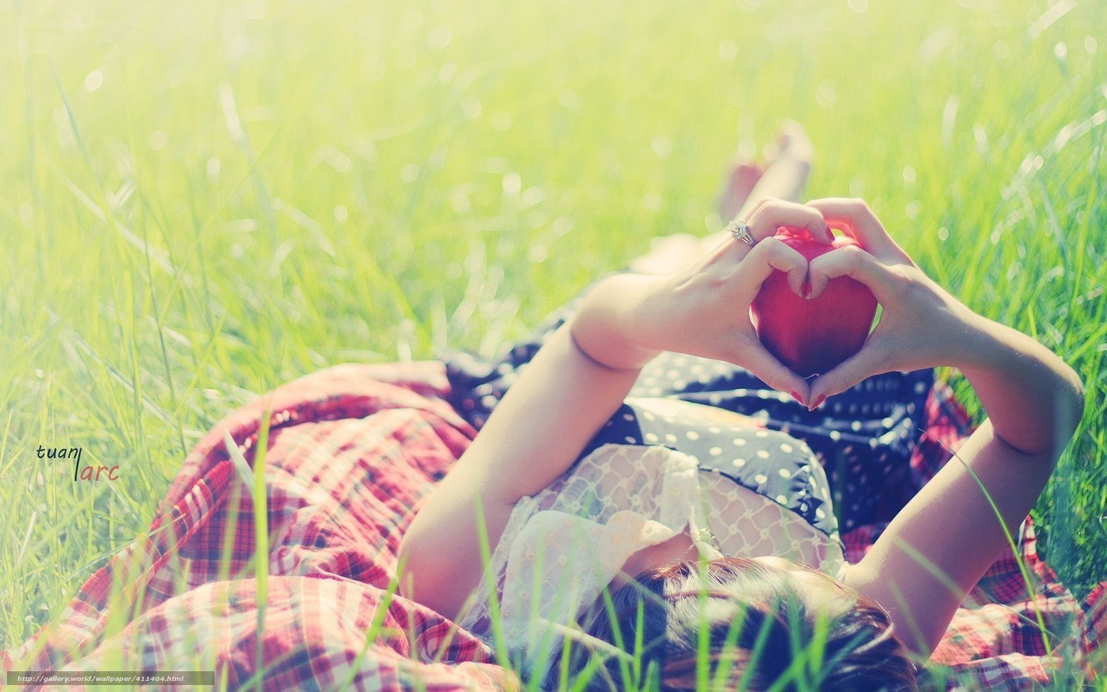 woman holding apple in grass