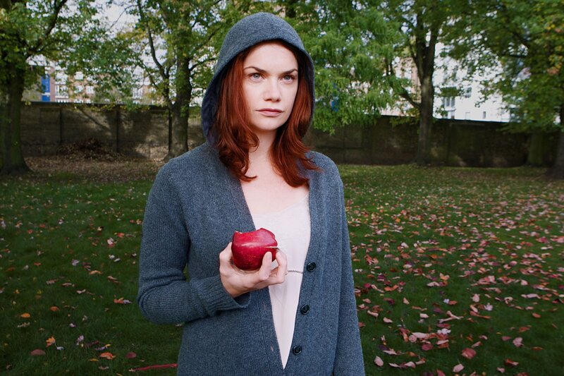 Woman holding apple in park