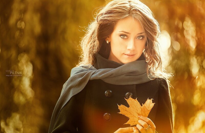 Woman Holding Autumn Leaf — Gold