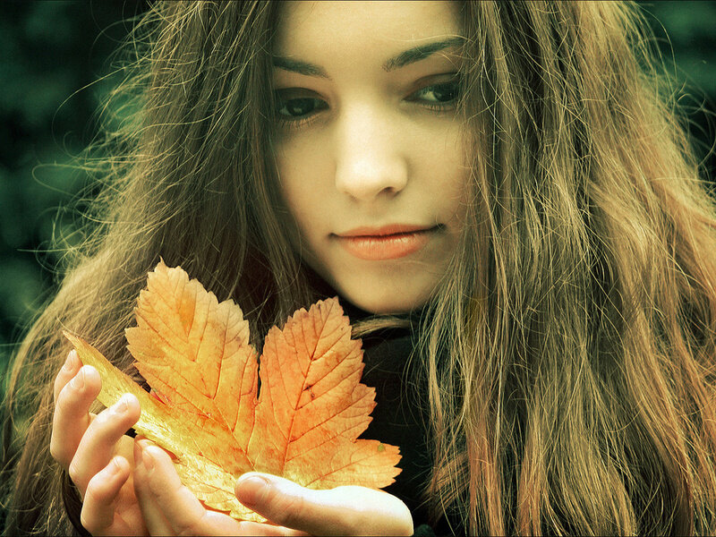 Woman Holding Autumn Leaf — Orange