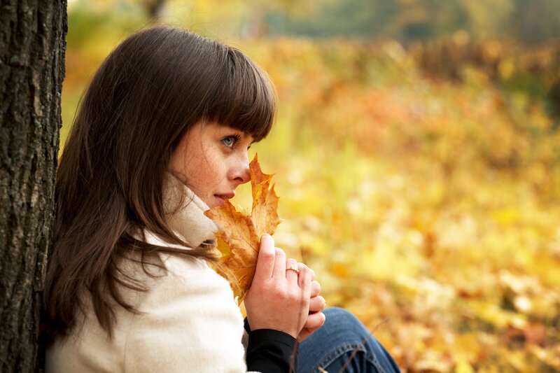 Woman Holding Autumn Leaf — Yellow