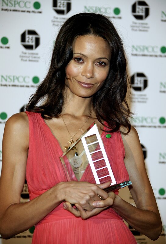 woman holding award at event