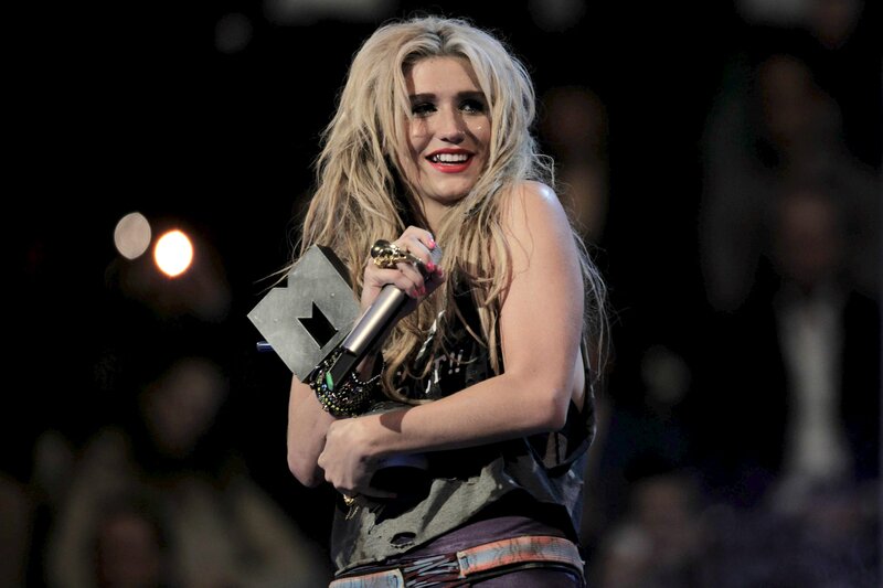 woman holding award on stage