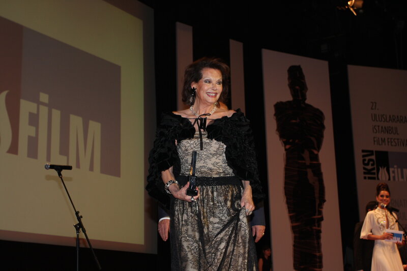 Woman holding award on stage