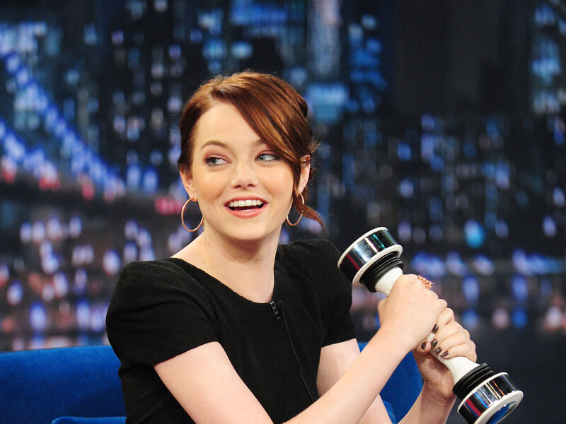 woman holding award on talk show