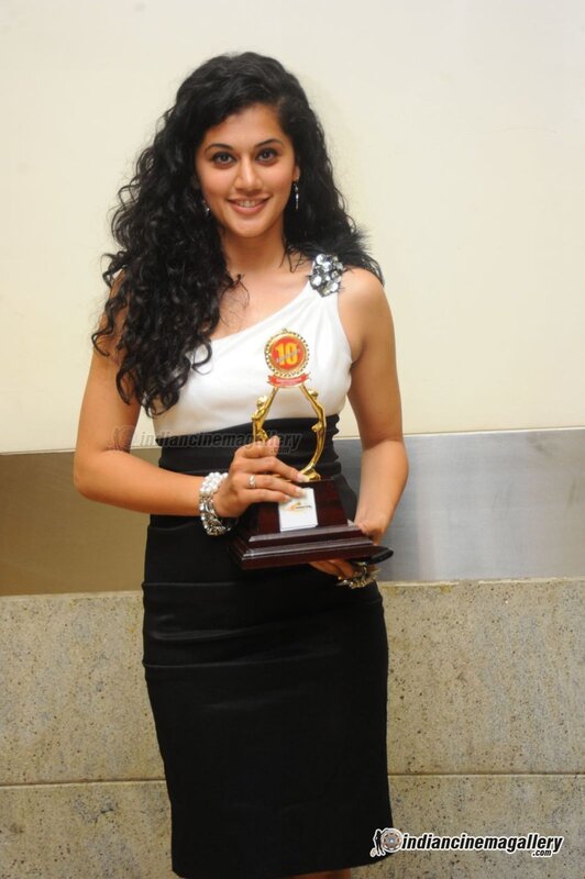 woman holding award trophy