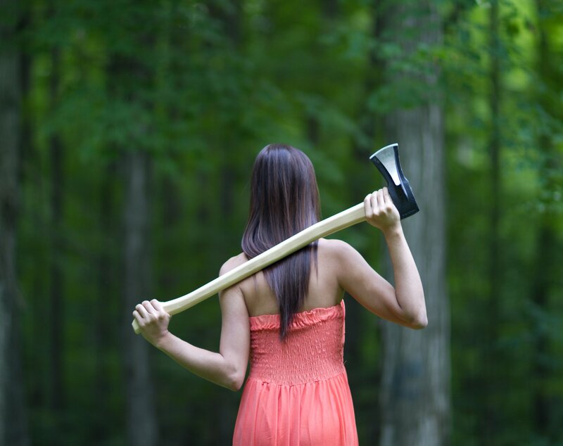 woman holding axe in forest