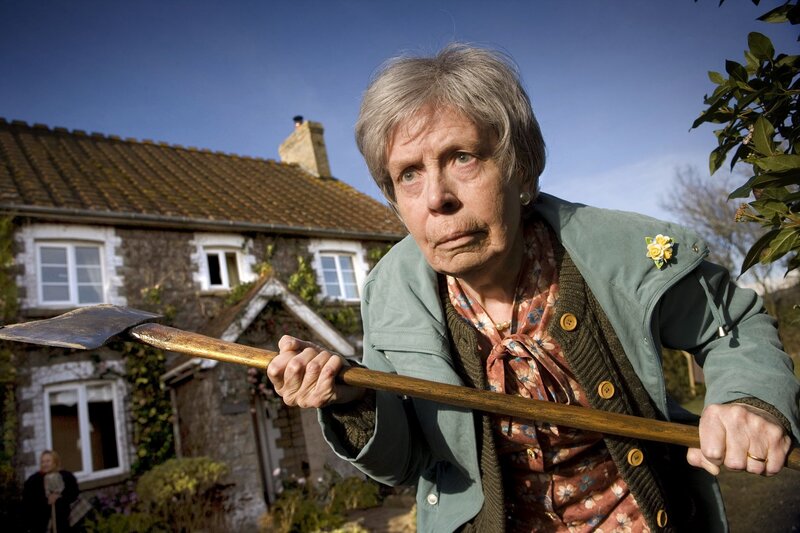 Woman holding axe in garden