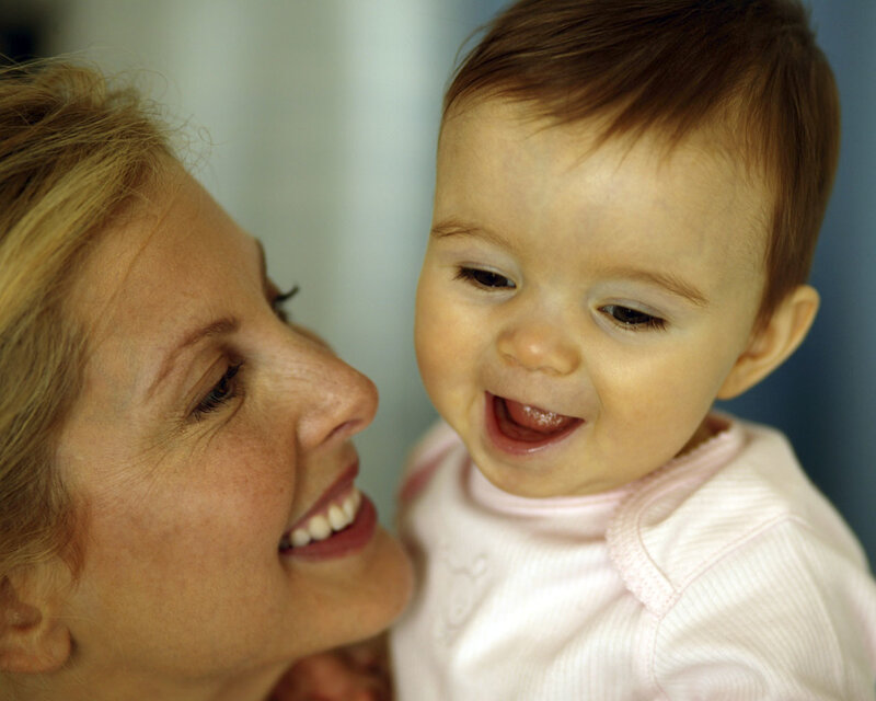 Woman Holding Baby — Pink
