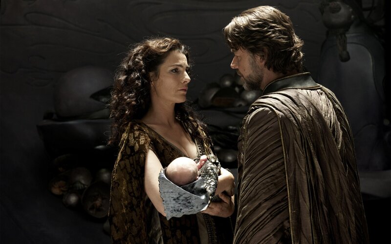 woman holding baby with man