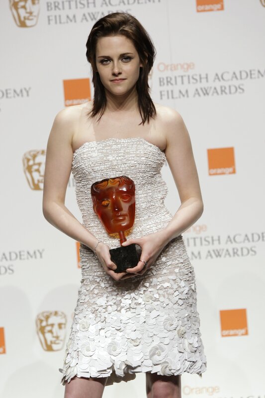 woman holding bafta award