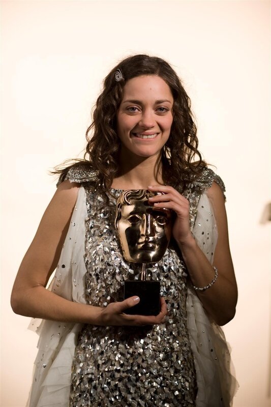 woman holding bafta award