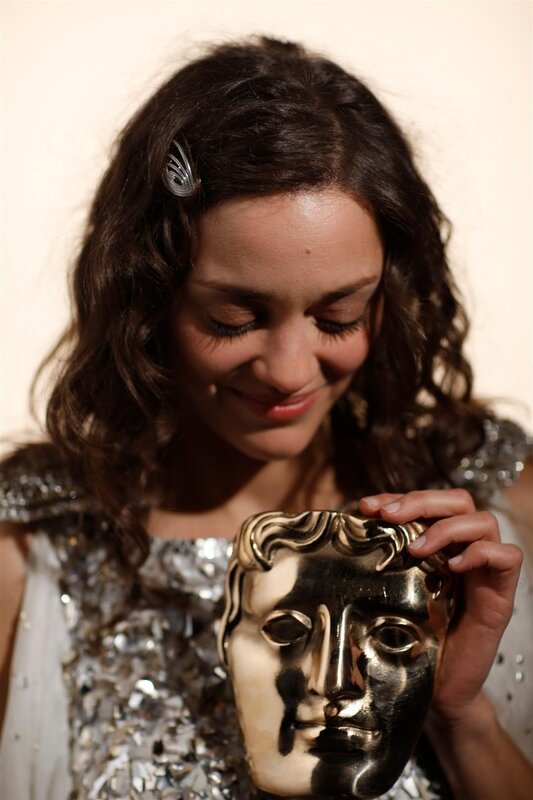 woman holding bafta mask